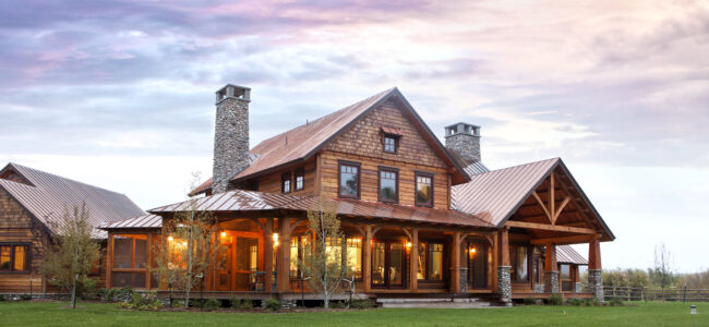 timber frame home sitting beneath evening sky and above green grass