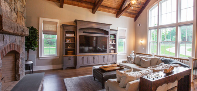 living room with large entertainment center and white section couch in menham nj