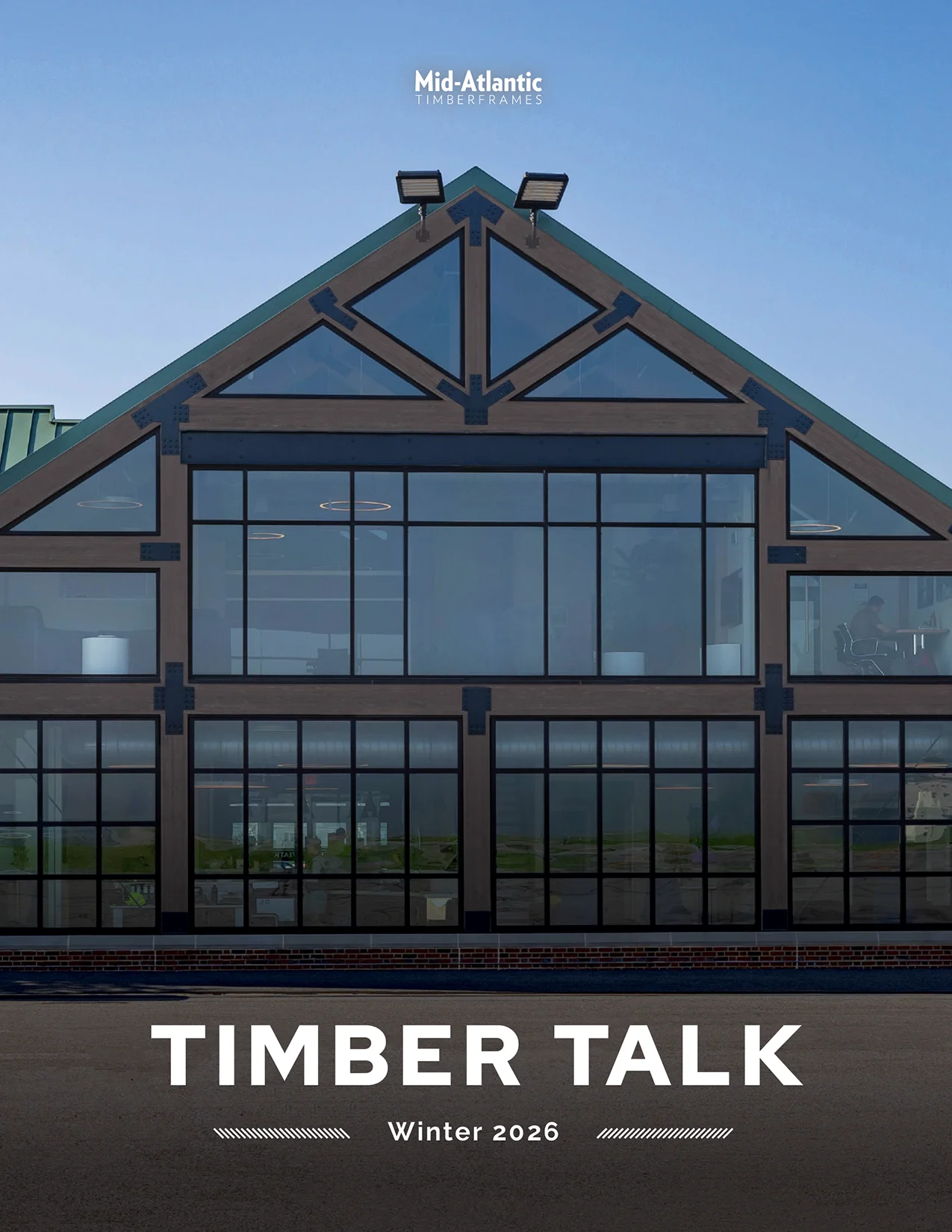Cover of “Timber Talk” magazine featuring the exterior of a timber frame structure with large glass windows. Header reads Mid-Atlantic Timberframes. Issue is Winter 2026.